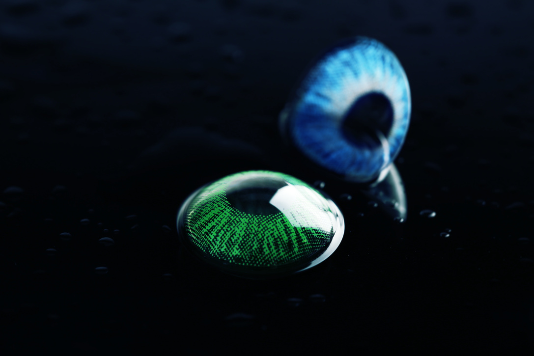 Blue and Green Contact Lenses on Black Background